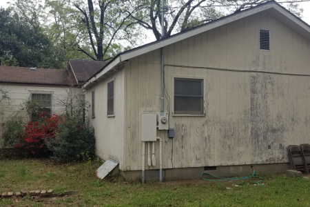Photo of house that desperately needs cleaning and repainting
